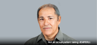 Man with gray hair wearing a gray collared shirt